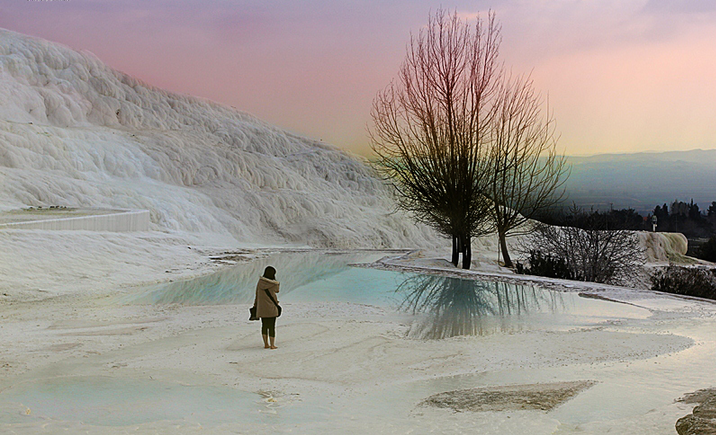 un “Castello di cotone” a sud della Turchia: Pamukkale, un sito termale dal fascino paradisiaco ma con una porta da cui fuoriesce il fiato degli inferi. Quello che rende questo luogo così affascinante sono le sue terrazze di travertino bianche colme d’acqua di un turchese intenso. I movimenti tettonici hanno permesso la nascita di numerose fonti termali. L'acqua calda, ricca di carbonato di calcio, scendendo lungo la montagna, ha formato queste tipiche terrazze color neve che sembrano di cotone.
