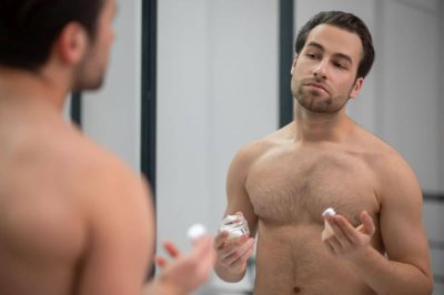 half-naked-man-standing-near-mirror-applying-shaving-foam-his-face.jpg